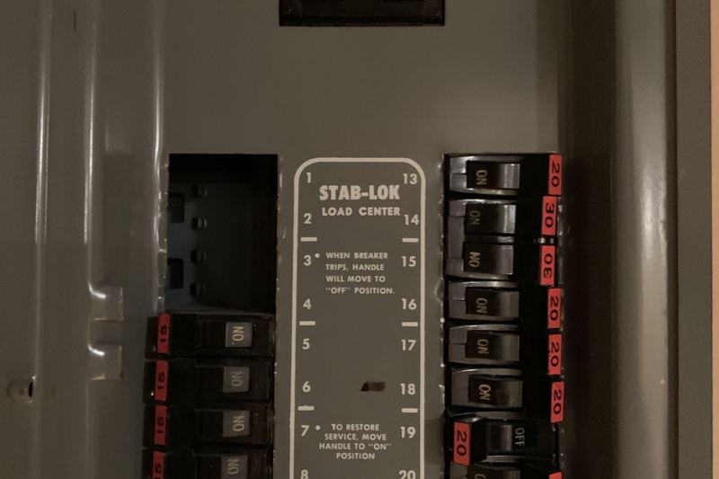 Interior of a circuit breaker panel with bus and breakers